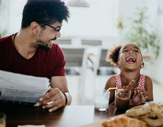 Dad and daughter eating breakfast together